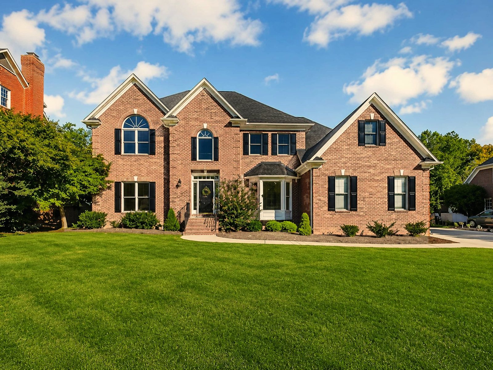Brick two-story estate home on a wide lawn in Jamestown, North Carolina, co-hosted by BookedMore