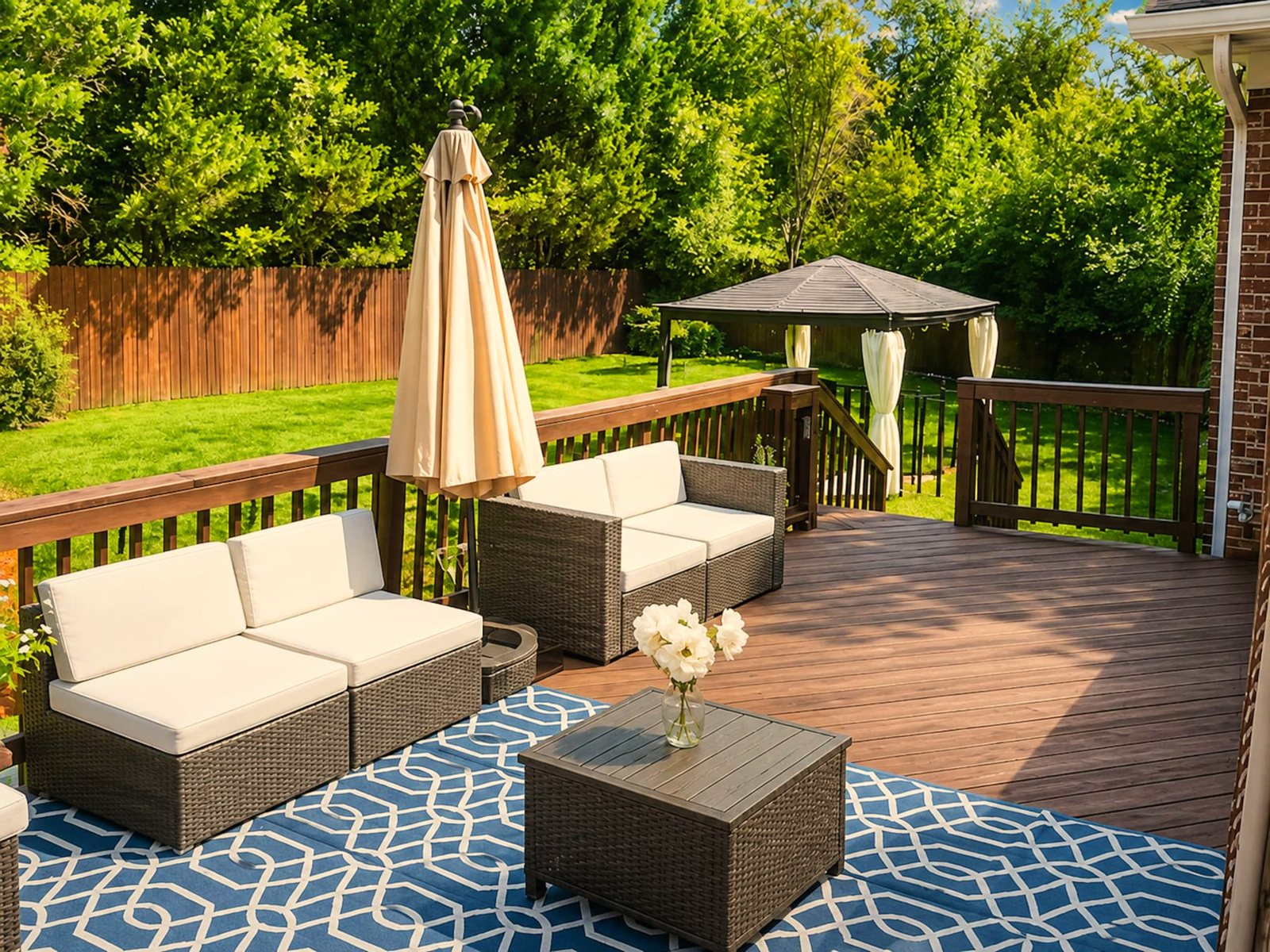 Back deck with an umbrella and outdoor seating at Duchess Ct in Jamestown, North Carolina
