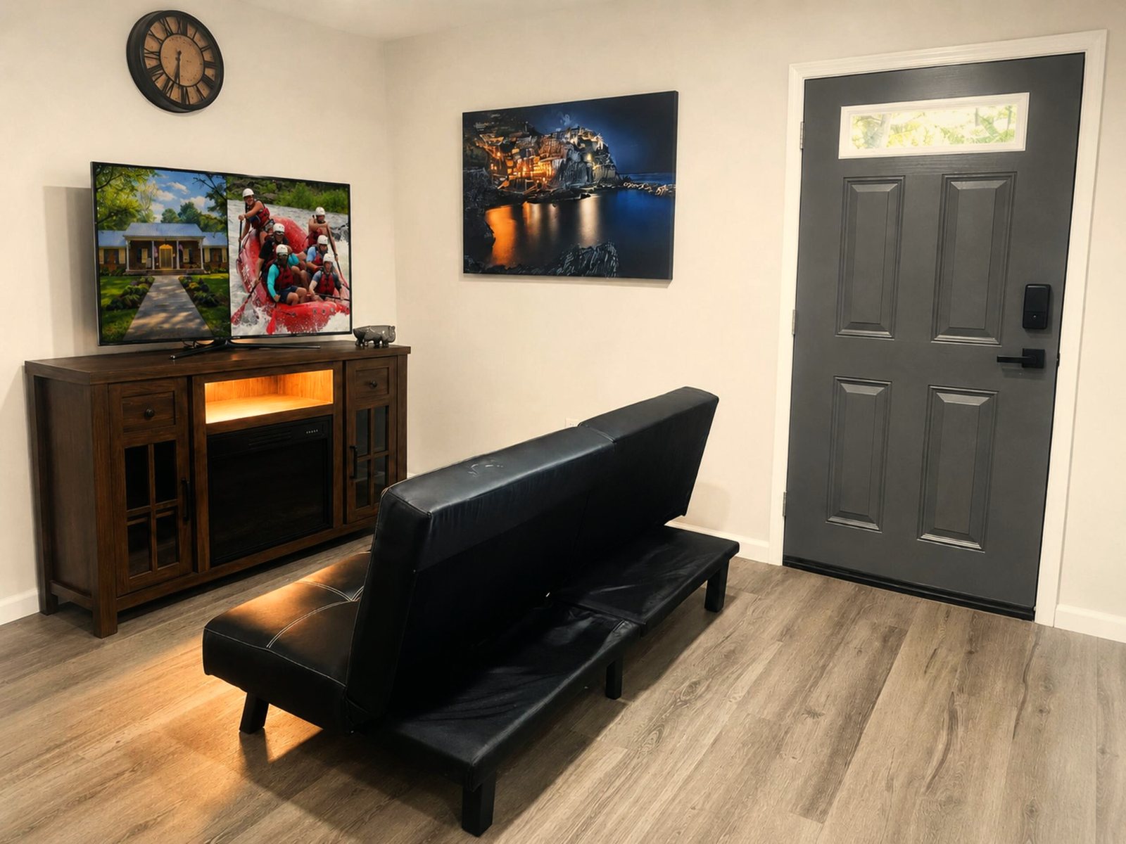 Studio living area with a futon, TV and smart-lock door at the Ocoee Lower Studio in Benton, Tennessee
