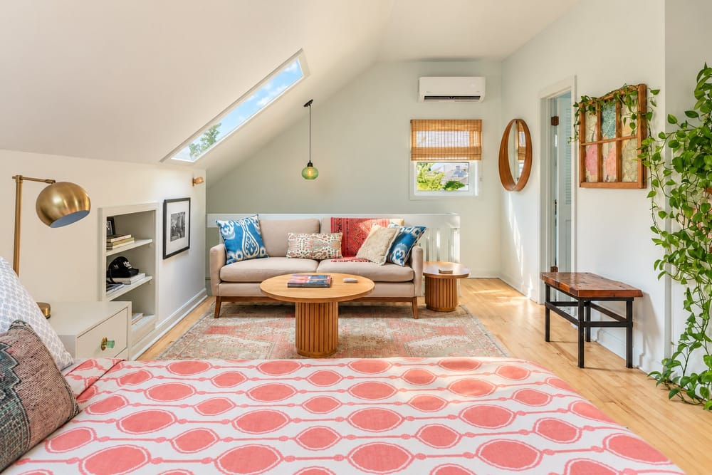Sunlit attic sitting room with a skylight and plants, a home BookedMore co-hosts