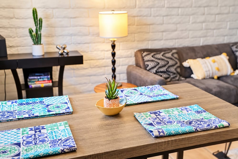 Dining nook set for guests with patterned placemats and a succulent, a home BookedMore co-hosts