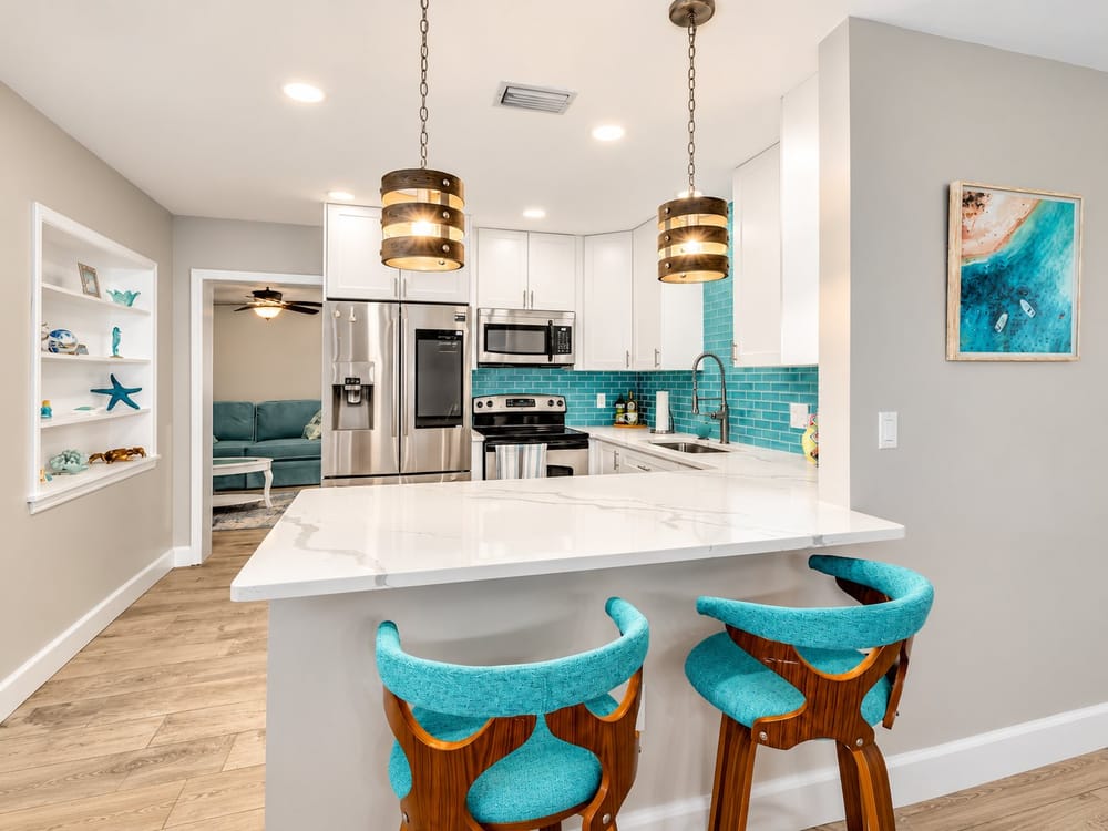 Renovated kitchen with turquoise tile and a quartz breakfast bar, a home BookedMore co-hosts